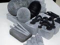 Many models printed on 3D printer. Gray and black objects printed 3D printer.