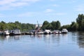 Many modern motorboats at pier on river at summer sunny da Royalty Free Stock Photo