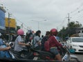 Many motorbike riders waiting and about to take off at a U-turn