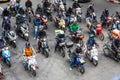 Many motorbikes motorcycles stopped at traffic lights waiting for the green light