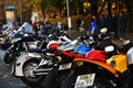 Many motorbikes stand in a row.
