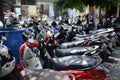 Many motorcycles and scooters parked in a line in the city of Kuta, Bali