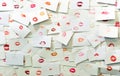 Many mouths with red lips painted with lipstick printed on white paper cards.