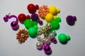 Many multi-colored earrings on a white background, in the form of balls and colors of metal and plastic. Royalty Free Stock Photo