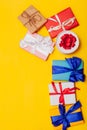 Many multi-colored gifts for the holiday on a yellow background