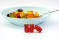 Many multi-colored jelly bears in a plate on a white background. Close-up. Royalty Free Stock Photo