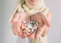 Many multi-colored pills in a woman hands on white background Royalty Free Stock Photo