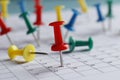 Many multi-colored pins of different dates on a calendar close-up. Important date. Royalty Free Stock Photo