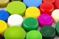Many multi-colored plastic bottle caps on a white background Royalty Free Stock Photo