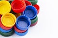 Many multi-colored plastic bottle caps on a white background Royalty Free Stock Photo