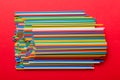 many multi-colored plastic tubes for cocktail on Colored background, top view Royalty Free Stock Photo