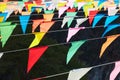 Many multi colored triangular flags hanging on the ropes as a holiday decoration Royalty Free Stock Photo