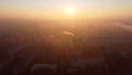 Many multi-storey buildings, chimney with smoke. Bright shining sun Dawn sunrise