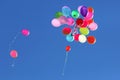 Many multicolored balloons flying in the blue sky Royalty Free Stock Photo