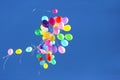 Many multicolored balloons flying in the blue sky Royalty Free Stock Photo