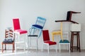 Many multicolored chairs in the mess of the white room