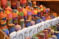 Many multicolored colorful red orange yellow paraffin stick candles arranged on shelves Royalty Free Stock Photo