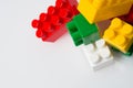 Many multicolored cubes of children`s constructor blocks on a white background top view with copy space. Concept Royalty Free Stock Photo