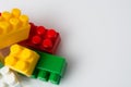 Many multicolored cubes of children`s constructor blocks on a white background top view with copy space. Concept building plans Royalty Free Stock Photo