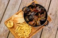 Many mussels in saucepan and side dish. Royalty Free Stock Photo