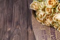 Many natural beige roses background on a wooden table Royalty Free Stock Photo