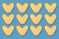 many natural heart-shaped potato isolated on blue background