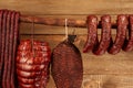 Many natural sausage and ham hanged on wooden stick Royalty Free Stock Photo