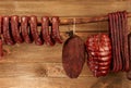 Many natural sausage and ham hanged on wooden stick Royalty Free Stock Photo