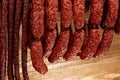 Many natural sausage hanged on wooden background Royalty Free Stock Photo