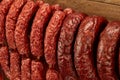 Many natural sausage hanged on wooden background Royalty Free Stock Photo