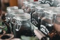many neat and clean glass jars containing tea tightly closed with a wire lid arranged on a shelf, the mylk bar, new