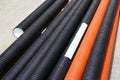 New orange and black plastic pipes on construction site Royalty Free Stock Photo