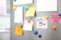 Many notes and empty sheets with magnets on refrigerator door in kitchen Royalty Free Stock Photo