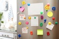 Many notes and empty sheets with magnets on refrigerator door in kitchen Royalty Free Stock Photo