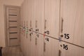 Many numbered wooden lockers with keys indoors