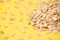 Many of oat flakes. Yellow bright background. Healthy eating