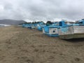 Many old blue and white fishing boats lined up on the beach Royalty Free Stock Photo