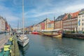 Old boats, yachts and ships stand along the Nyhavn canal and colorful houses. Copenhagen, Denmark