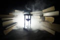 Many old books in a stack. Knoledge concept. Books on a dark background with smoke elements. Bewitched book in center