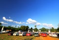 Many old Classic Mini Austin cooper parked on grass field with green tree and clear blue sky background Royalty Free Stock Photo