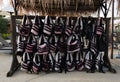 Many old life jackets hang on bar at the beach