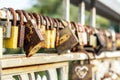 Many old rusty metal locks closed on fence of bridge over river. Love forever through time concept Royalty Free Stock Photo