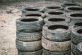 Many old used car tires stacked on top of each other on Automobile sports complex. Industrial landfill for the