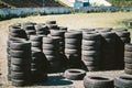 Many old used car tires stacked on top of each other on Automobile sports complex. Industrial landfill for the