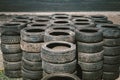 Many old used car tires stacked on top of each other on Automobile sports complex. Industrial landfill for the