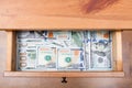 Many one hundred dollar bills on bottom of drawer Royalty Free Stock Photo