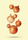 Many onion bulbs falling on beige background