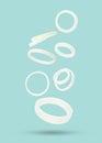 Many onion rings falling on pastel light blue background