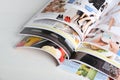 Many open magazines on white wooden table, above view Royalty Free Stock Photo