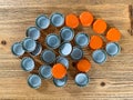 Many orange beer lids, bottle corks tops on a wooden texture top view Royalty Free Stock Photo